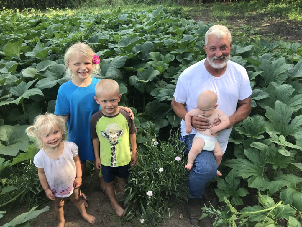 Bouwkamp family with crops - image